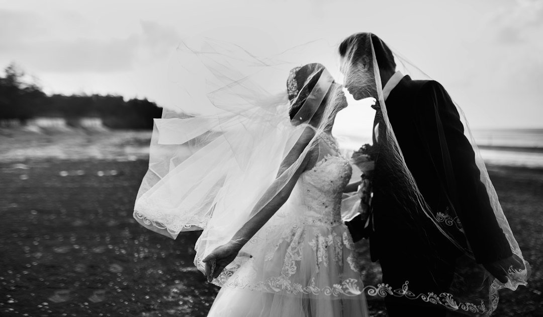 Couple on a windy beach on their wedding day